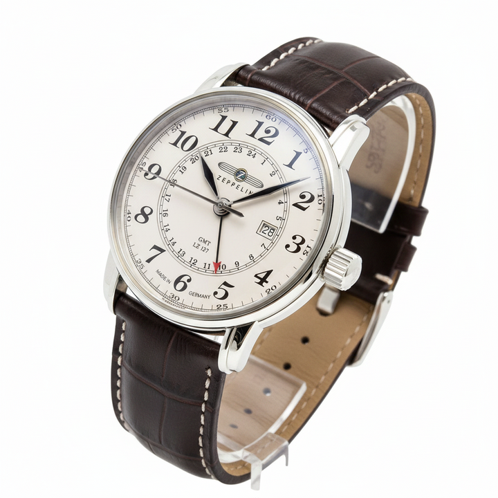 Watch with brown leather strap and white face on a white background